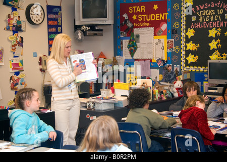 Female fourth grade teacher with students in a classroom in Tampa Florida Stock Photo