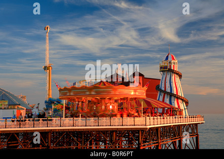 Sunset over the Funfair Palace Pier Brighton Sussex England Britain UK Stock Photo