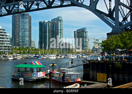 Small commuter passenger ferry water taxi docked at the entrance to Vancouver s busy False Creek. Stock Photo