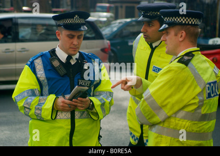 Police officers on duty in London with one female head turned amongst ...