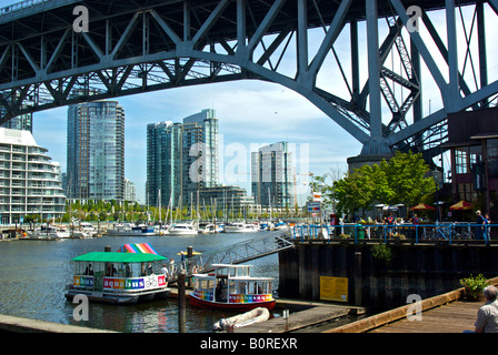 Small commuter passenger water taxi ferry docked at the entrance to Vancouver s busy False Creek. Stock Photo