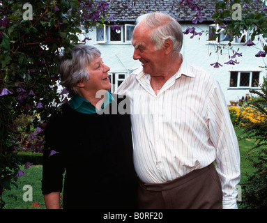 Senior couple in front of their home Stock Photo