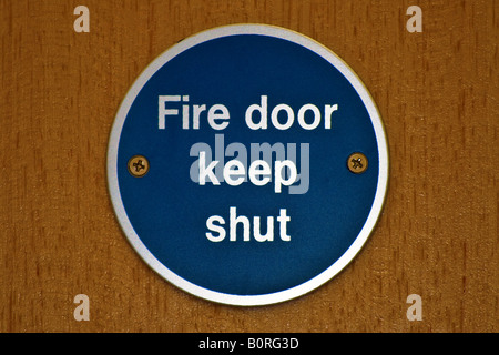 Blue fire door keep shut sign Stock Photo