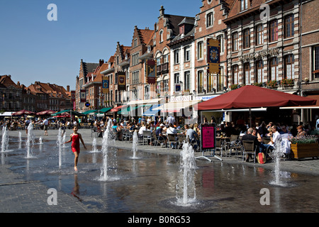 Girl playing in fountains in Grand Place town square Tournai Belgium Stock Photo