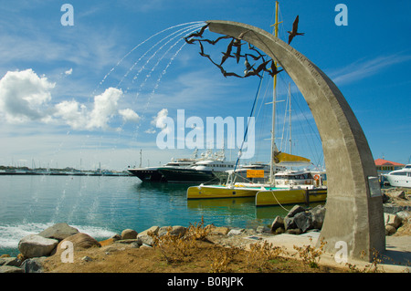 A seaside water fountain sculpture at the marina in Marigot Saint Martin French Protectorate Stock Photo