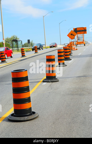 Road construction signs and cones on city street Stock Photo