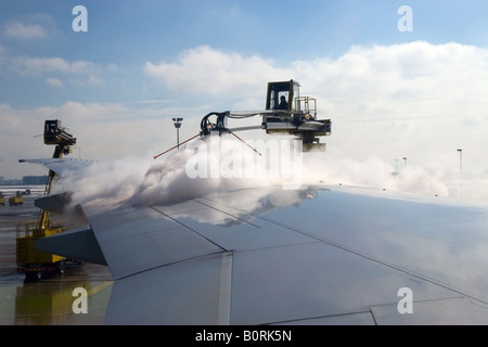 De-ice airplane during winter before takeoff. Stock Photo