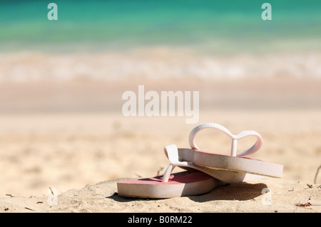 Flipflops on a sandy ocean beach vacation concept Stock Photo