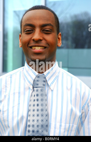 Portrait of a young handsome businessman next to a corporate building Stock Photo