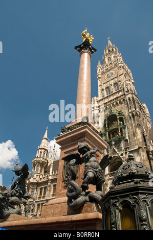 Statue of Virgin Mary with Neues Rathaus Mariensaeule tower in Marienplatz, town hall, in the city of Munich capital of  Bavaria. Germany Stock Photo