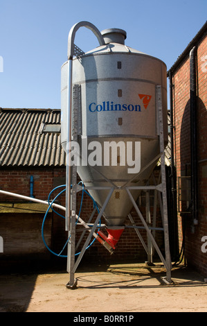 Aluminum hopper holding animal feed in farm yard Lancashire England Stock Photo