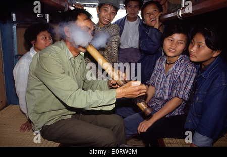 Vietnamese man smoking tobacco with traditional bamboo pipe, Old ...
