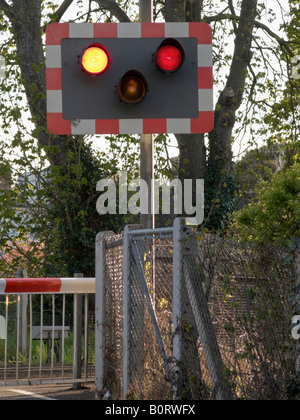 Level crossing barrier traffic stop signal light. Stock Photo