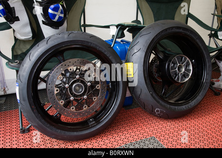 Front and rear wheels from a racing motorcycle. Brands Hatch racing Circuit, Kent, England. Stock Photo