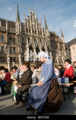 Germans attending a catholic mass outdoor in front of Marienplatz, town hall in the city of Munich capital of Bavaria Germany Stock Photo