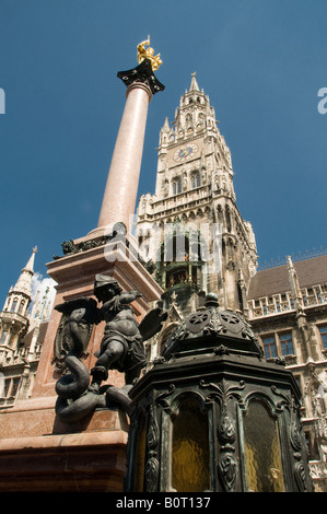 Statue of Virgin Mary with Neues Rathaus Mariensaeule tower in Marienplatz, town hall, in the city of Munich capital of  Bavaria. Germany Stock Photo