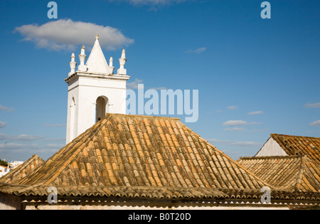 skyline in Albufeira Algarve Portugal with the square spire of a local chapel and the traditional red roof tiles Stock Photo