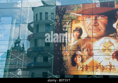 A film poster featuring Harrison Ford as Indiana Jones attached to a glassed building center in the city of Munich capital of  Bavaria. Germany Stock Photo