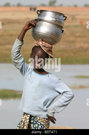 Peul girl carrying milk Stock Photo