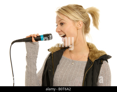Young woman singing holding microphone Stock Photo