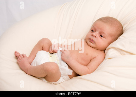 Newborn Baby Boy Joshua Kailas Hudson Aged 20 days Lying in Beanbag Stock Photo