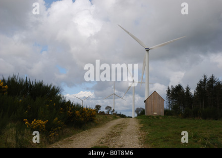 four windmachines in a windfarm near  Guerledan lake in Brittany Bretagne France Stock Photo