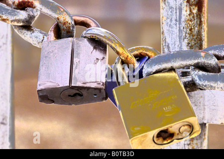 closeup view of padlock and chain link fence at power substation Stock Photo