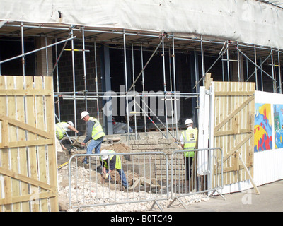 Bricklayers on building site, in North Bay development, Scarborough, England. Stock Photo