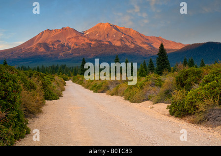 Dirt road below Mount Shasta Volcano at sunset Cascade Range Siskiyou County California Stock Photo