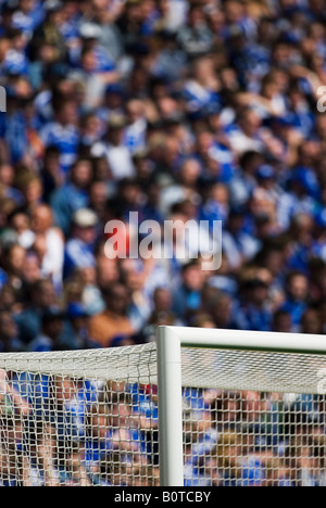 upper goal corner in filled football stadium Stock Photo