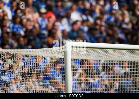 upper goal corner in filled football stadium Stock Photo