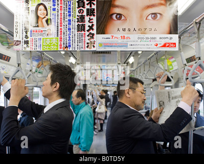 Advertising poster in carriage on railway train in Tokyo Japan Stock Photo