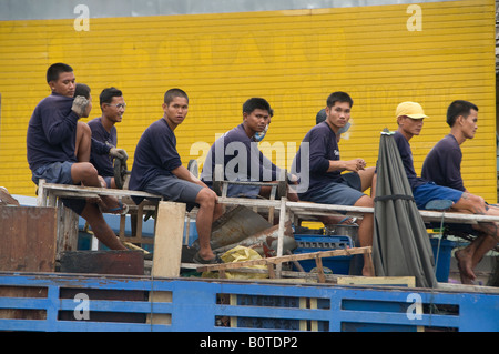 Workers on a truck, Bangkok, Thailand Stock Photo