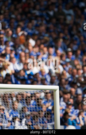 upper goal corner in filled football stadium Stock Photo