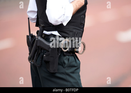 PSNI police service northern ireland officer wearing utility belt of handcuffs baton glock pistol Stock Photo