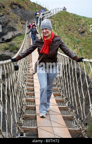 Woman Crossing Rope Woman crossing rope bridge on assault course Stock Photo - Alamy