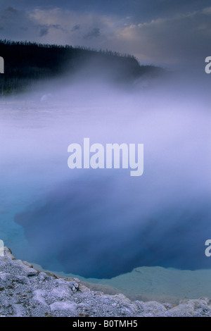 Steam rising off Sapphire Pool on a stormy evening Biscuit Basin ...