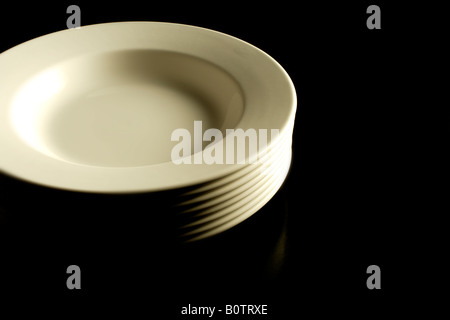Plates against black background Stock Photo