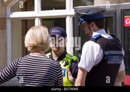 Police community support officer and Local Authority officier talk to a tourist in Winchester Stock Photo