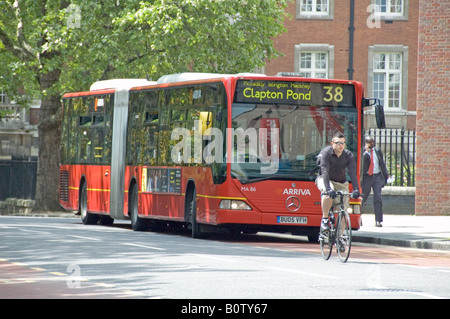 Cyclist in front of bendy bus Roseberry Avenue Islington London UK Stock Photo
