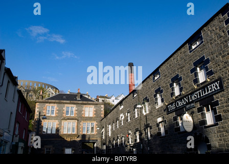 Oban distillery with McCaig's Tower in background, Oban, Scotland Stock Photo
