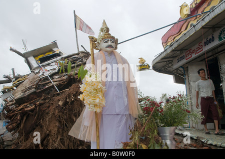 Buddhist statue stands among damage caused by tropical cyclone Nargis in center of Yangon, Myanmar,  Burma Stock Photo
