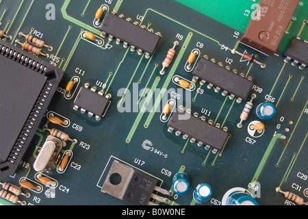 Integrated circuits or silicon chips on a circuit board motherboard with electronic components including resistors. Stock Photo