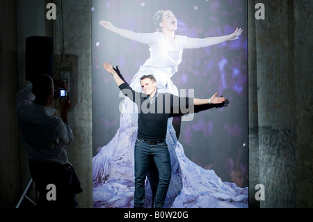 photographer taking a picture a man stading in front of a photo of Bjork Stock Photo