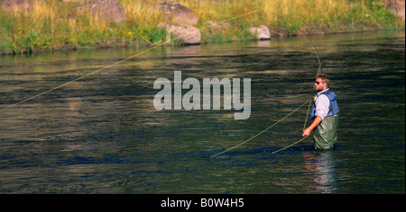 Fly fisherman on the Madison River near West Yellowstone Yellowstone National Park MONTANA Stock Photo