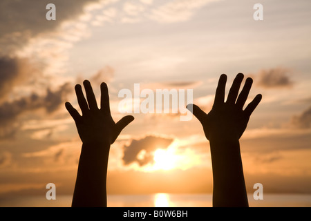 Woman's hands reaching for sky Stock Photo