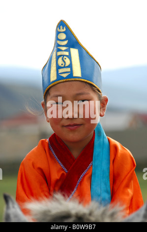 Portrait of a ten-year-old girl wearing hat with soyombo emblem riding a horse, participant in the horsemanship competitions of Stock Photo