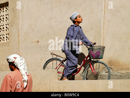 Boy riding his bicycle, Nizwa, Oman, Middle East Stock Photo