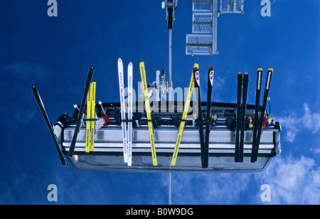 Seven skiers sitting on a chair of a chair lift, skis viewed from below, Ischgl, Idalpe, Tyrol, Austria, Europe Stock Photo