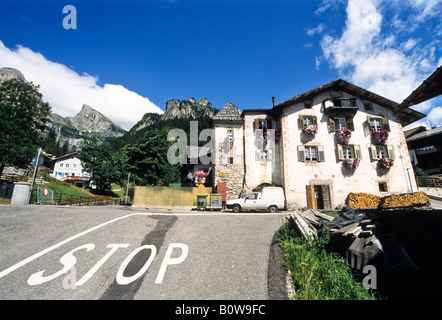 Street, stop marked on pavement in front of old farmhouse decorated with flowers in Viech, Vigo di Fassa, Trento, Italy, Europe Stock Photo